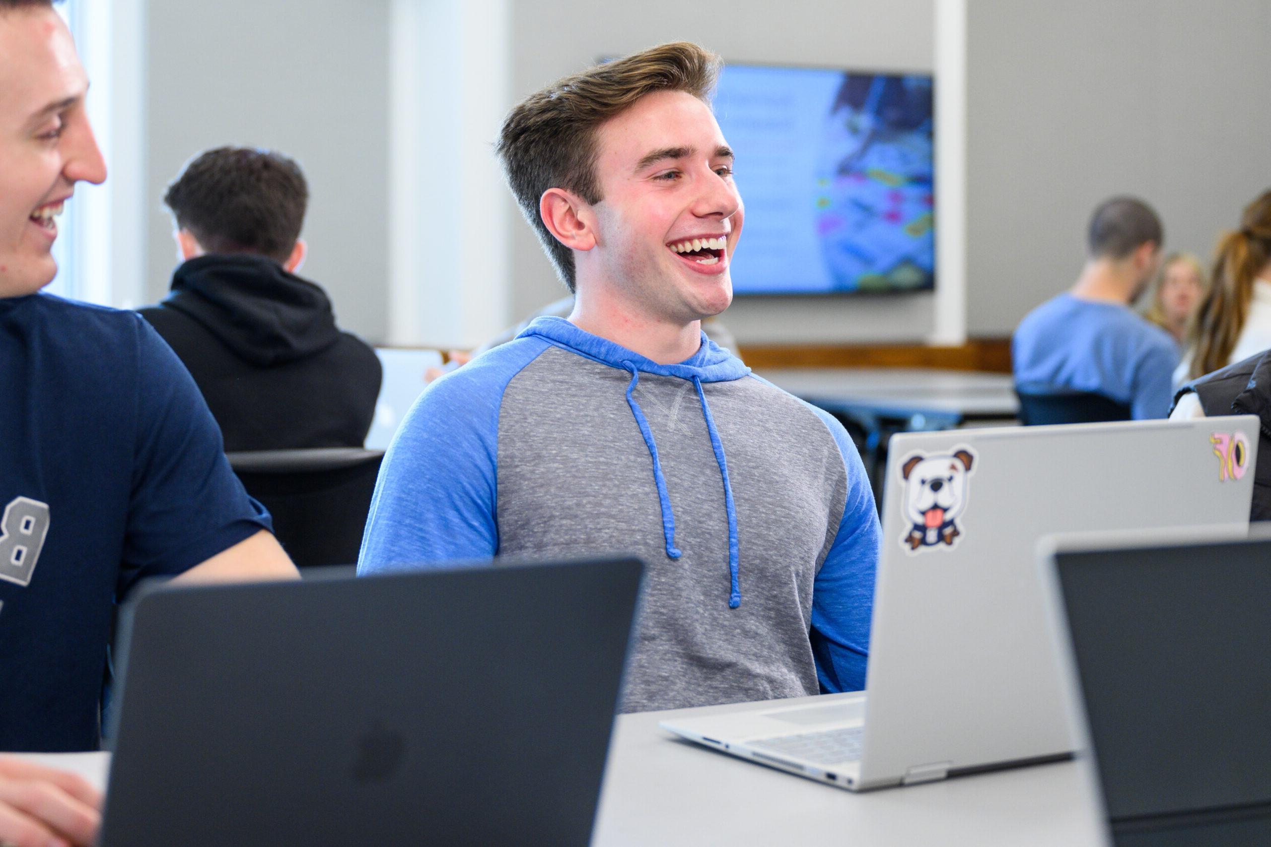 Male 博彩平台排名 student smiling during class.